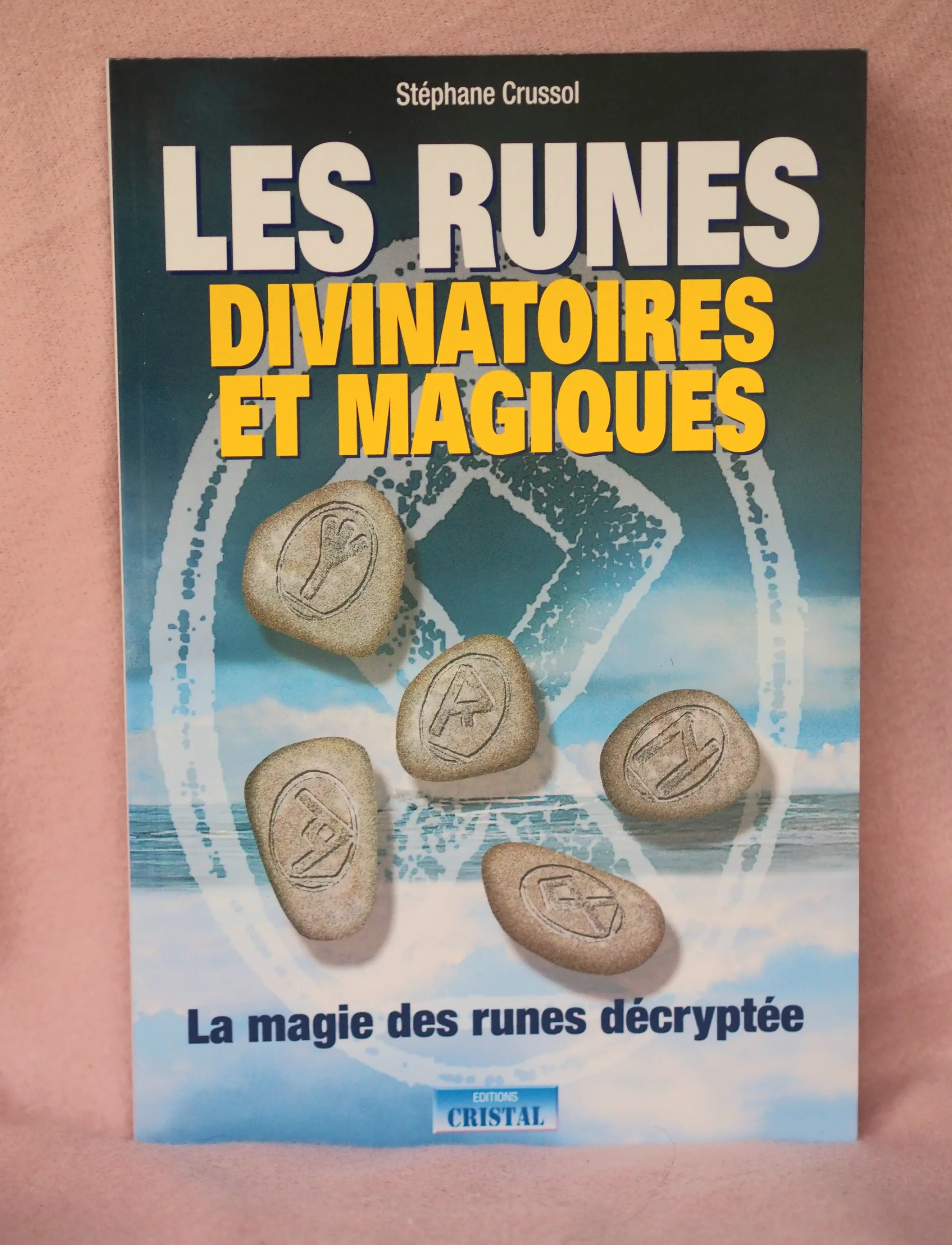 Couverture du livre « Les runes divinatoires et magiques » de Stéphane Crussol, aux Éditions Cristal, avec des pierres gravées de runes